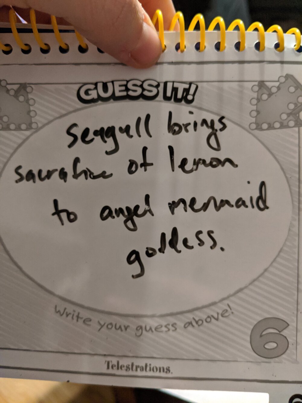 While we’re really missing the friends and family we used to play games with, Telestrations and DnD have become a way of LIFE lately.  [Photo: pictionary-style game answer that reads “Seagull brings sacricice of lemon to angel mermaid goddess”]