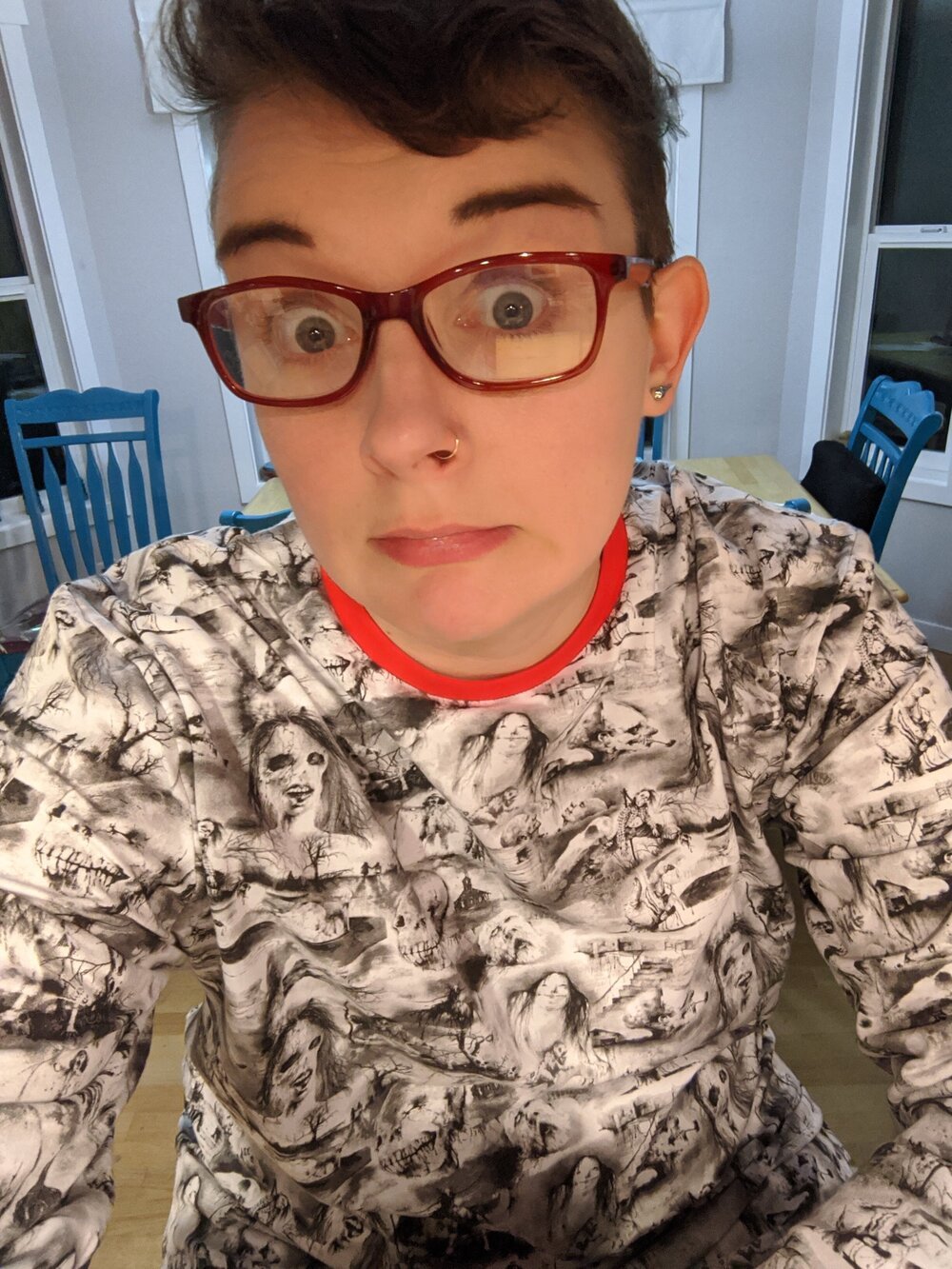 Pajamas my spouse got me for my birthday! [Pic: author making a silly face while wearing ‘Scary Stories to tell in the Dark” print pajamas’]